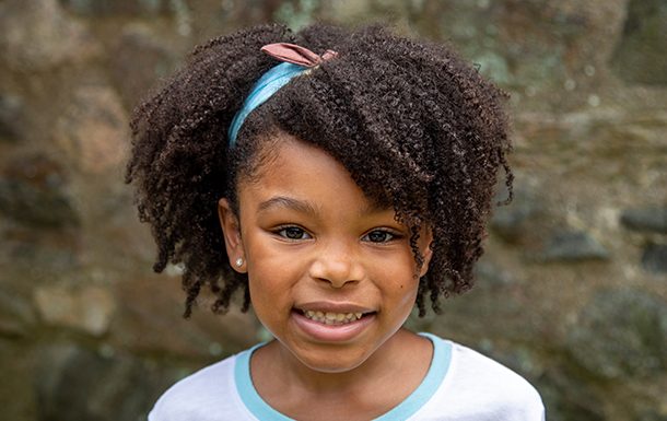little girl holding plant