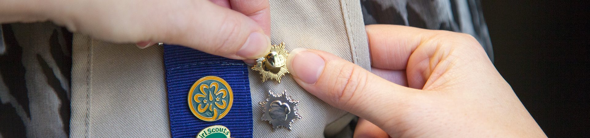  girl scout ambassador high school girl in school wearing sash with highest awards pins 