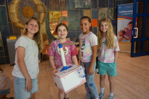Girl Scout Juniors in Germany with their crane
